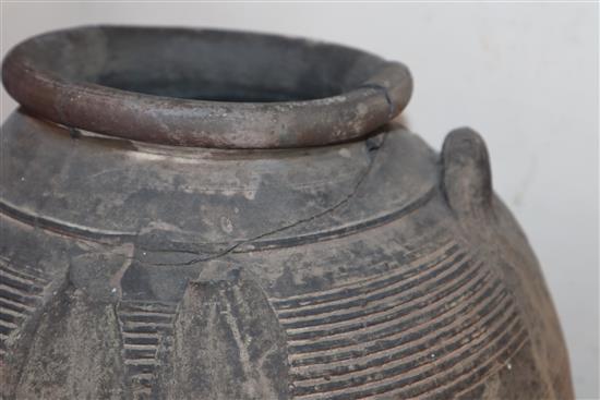 An Egyptian terracotta jar, with four carrying lug handles, Pre-Dynastic, H. 35cm, badly cracked